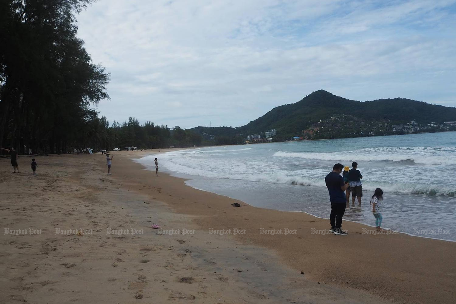 Local tourists at Kamala beach in Phuket. Most Phuket residents surveyed say they agree with a plan to reopen the country. (Photo by Dusida Worrachaddej­chai)