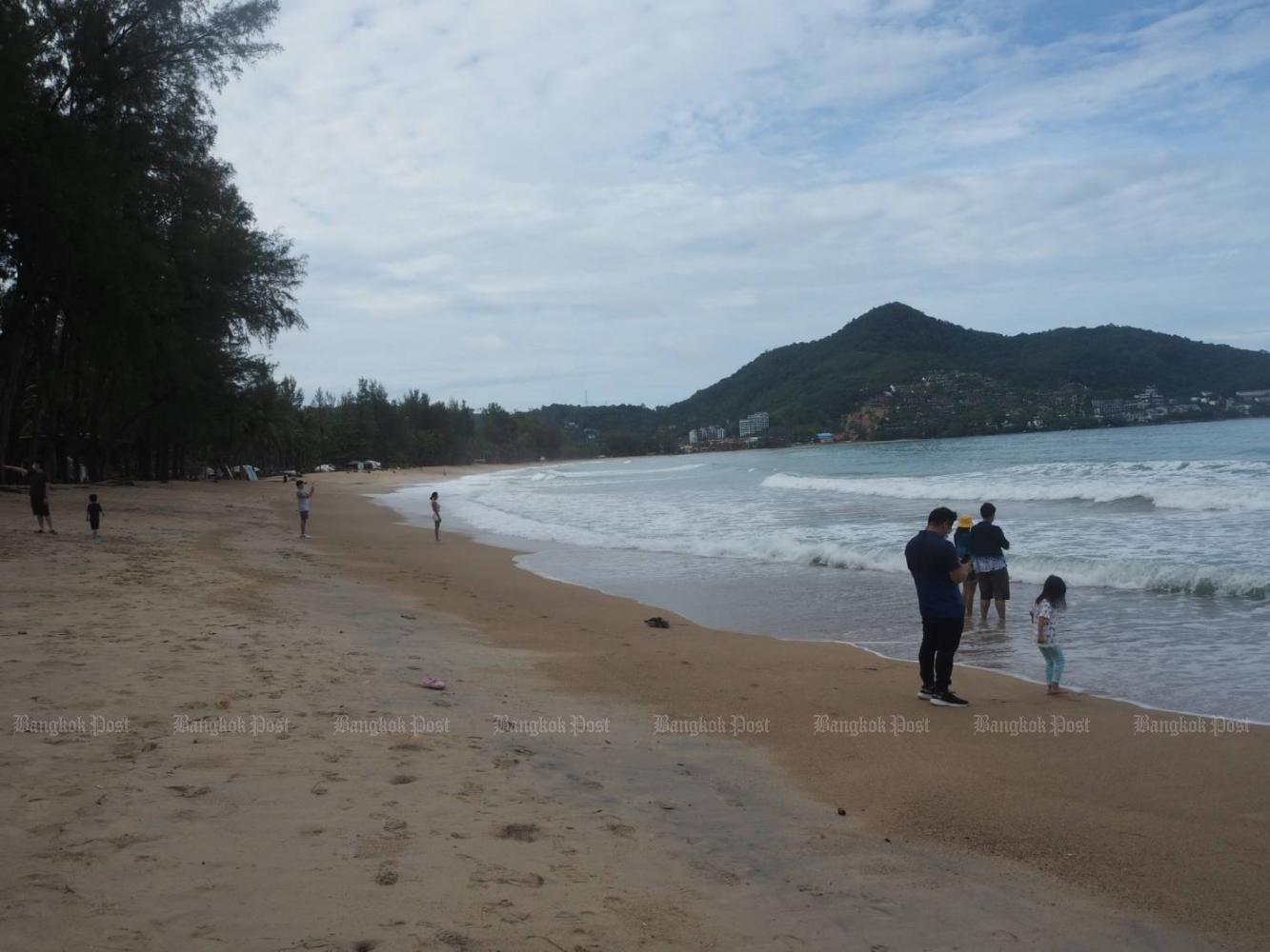 Local tourists at Kamala beach in Phuket. Most Phuket residents surveyed say they agree with a plan to reopen the country. Dusida Worrachaddej­chai