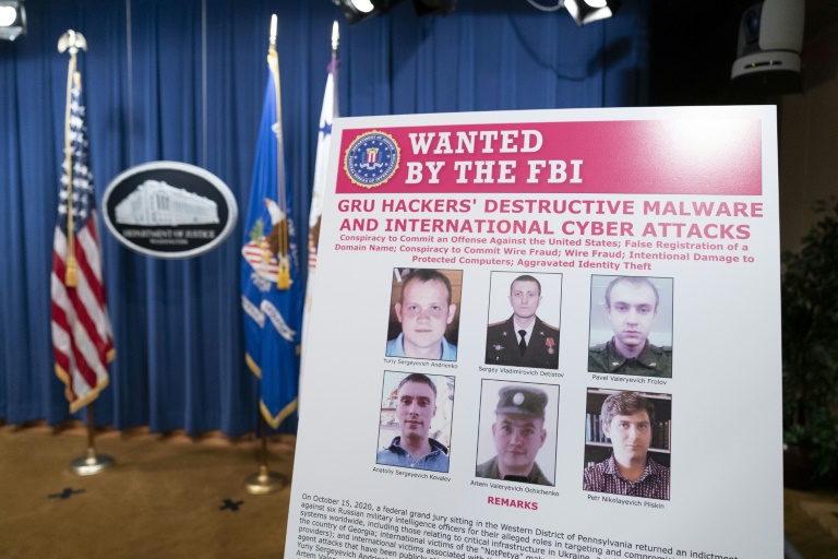 An FBI poster shows six Russian military intelligence officers accused of staging cyberattacks. An FBI poster shows six Russian military intelligence officers accused of staging cyberattacks.