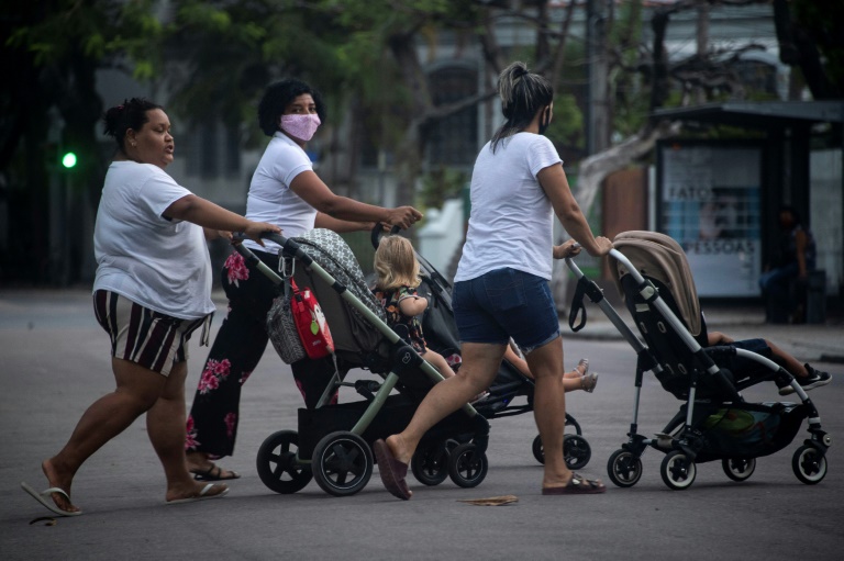 Babysitters push children in strollers in Rio de Janeiro in August 2020, amid the coronavirus pandemic. Babysitters push children in strollers in Rio de Janeiro in August 2020, amid the coronavirus pandemic.