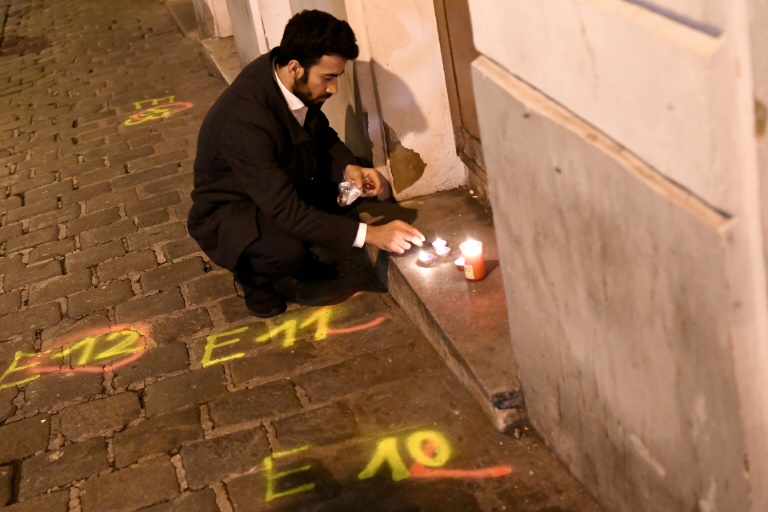 A man lights candles near the scene of the deadly shooting in Vienna. A man lights candles near the scene of the deadly shooting in Vienna.