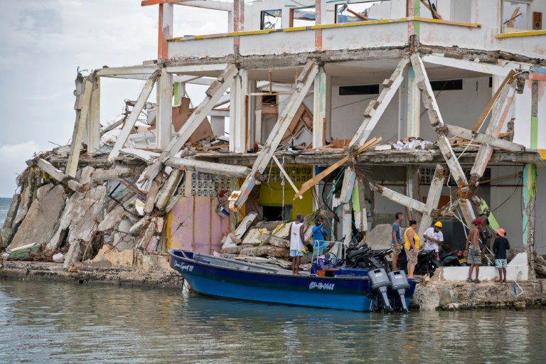 People inspect a damaged building after the passage of Hurricane Iota in Providencia, Colombia People inspect a damaged building after the passage of Hurricane Iota in Providencia, Colombia