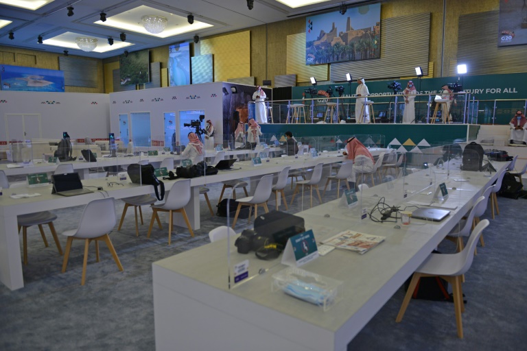 Journalists work in an almost empty media room set up for the coverage of the G20 summit, held virtually due to the coronavirus pandemic, in the Saudi capital Riyadh, on November 20, 2020. Journalists work in an almost empty media room set up for the coverage of the G20 summit, held virtually due to the coronavirus pandemic, in the Saudi capital Riyadh, on November 20, 2020.