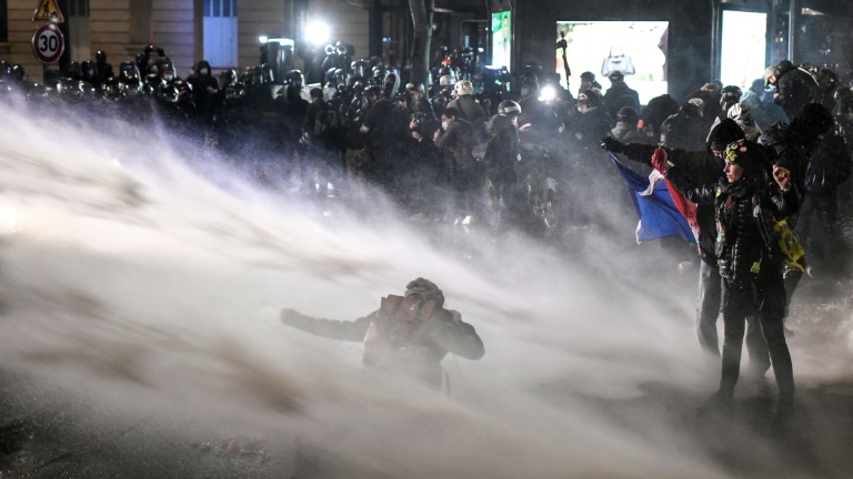 Police in Paris spray water cannon at protesters opposed to a French draft law seeking to limit the filming of police officers on duty. Police in Paris spray water cannon at protesters opposed to a French draft law seeking to limit the filming of police officers on duty.