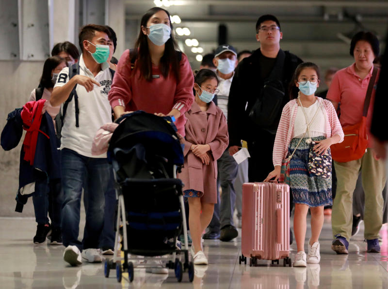 FILE PHOTO: Chinese tourists wear masks as they arrive at Suvarnabhumi Airport during a welcome ceremony of Chinese Lunar New Year travellers in Bangkok, Jan 22, 2020. (Reuters)