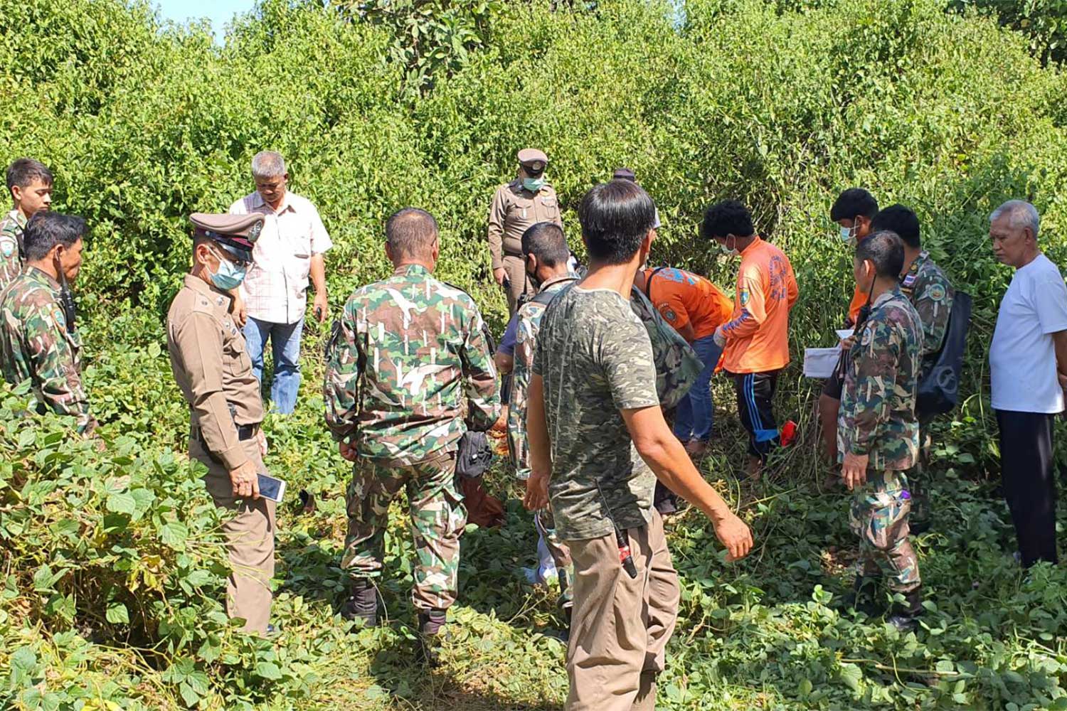 National park officials, police and volunteers inspect the body of a monk who was found dead with fractured legs and a broken skull at grasses not far from a monastery he stayed in Thong Pha Phum district, Kanchanaburi province, on Tuesday morning. National park officials, police and volunteers inspect the body of a monk who was found dead with fractured legs and a broken skull at grasses not far from a monastery he stayed in Thong Pha Phum district, Kanchanaburi province, on Tuesday morning.