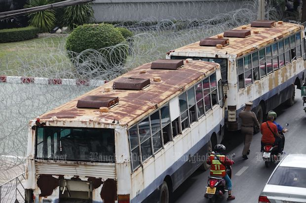 The wrecks of two old buses are seen placed to block the entrance and the exit of the 11th Infantry Regiment headquarters on Phahon Yothin Road in Bang Khen district of Bangkok on Sunday. (Photo by Wichan Charoenkiatpakul) The wrecks of two old buses are seen placed to block the entrance and the exit of the 11th Infantry Regiment headquarters on Phahon Yothin Road in Bang Khen district of Bangkok on Sunday. (Photo by Wichan Charoenkiatpakul)