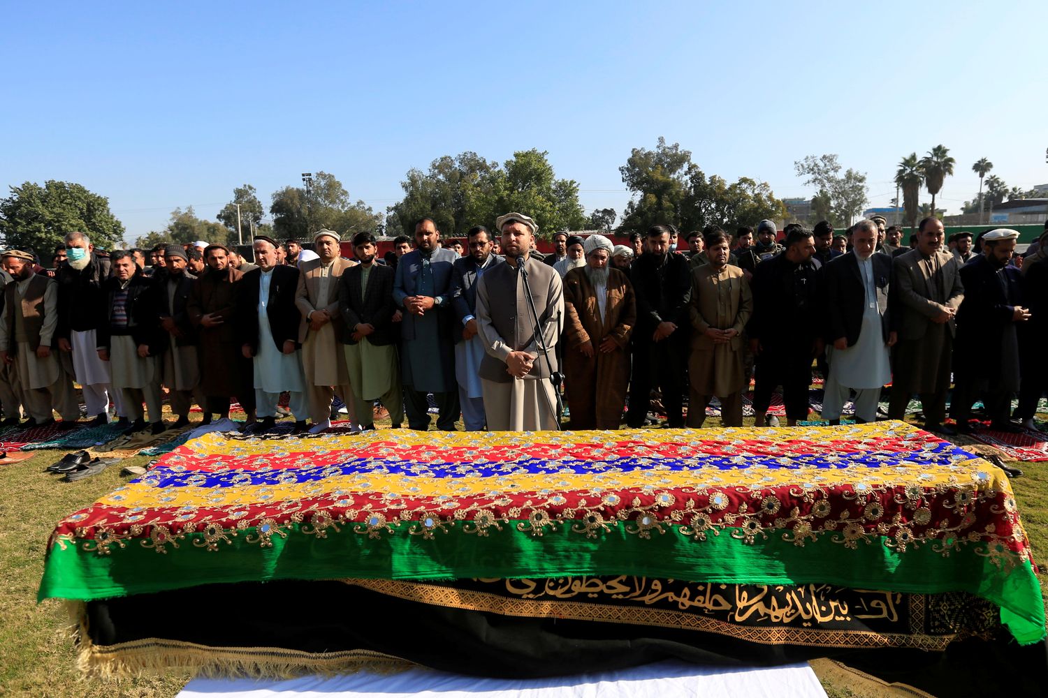 Afghan men pray near the coffin of journalist Malalai Maiwand, who was shot and killed by unknown gunmen in Jalalabad on Thursday. (Reuters photo)