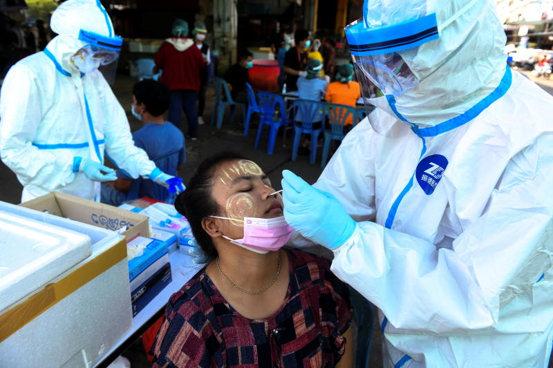 A medical worker performs a nose swab on a migrant worker at a seafood market linked to a coronavirus disease (Covid-19) outbreak, in Samut Sakhon province, on Saturday. (Reuters photo)