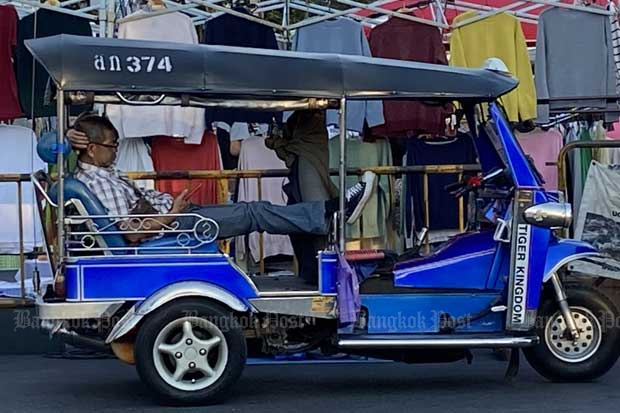 A tuk tuk driver waits for passengers near the famous walking street in Muang district of Chiang Mai province on Dec 28, 2020. (Photo by Saritdet Marukatat)