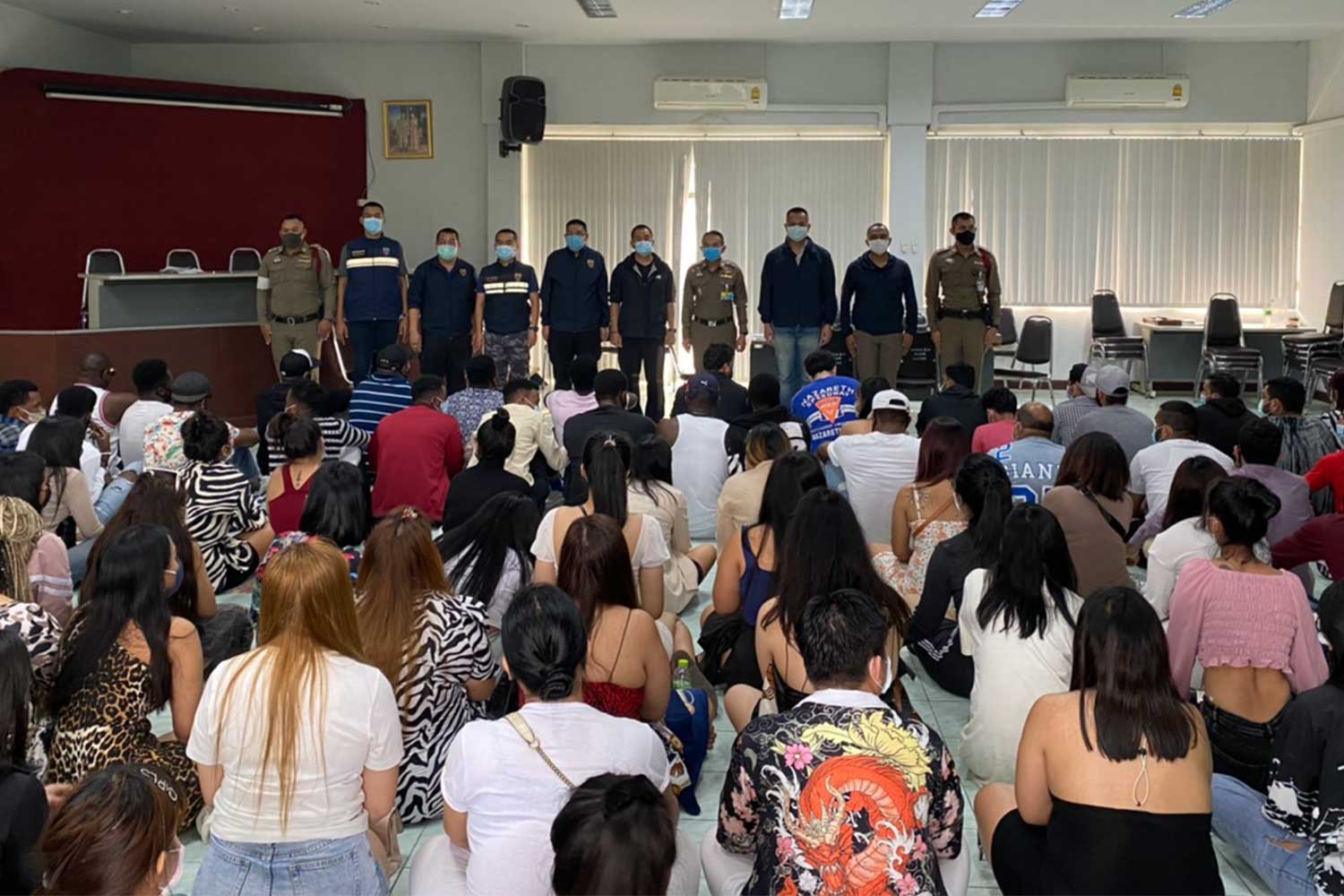 A total of 65 people, including customers and staff, await processing at the Lumpini police station after a raid on the Taj Café pub and Indian restaurant early Saturday. (Supplied photo via Wassayos Ngamkham) A total of 65 people, including customers and staff, await processing at the Lumpini police station after a raid on the Taj Café pub and Indian restaurant early Saturday. (Supplied photo via Wassayos Ngamkham)