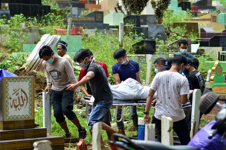 Search-and-rescue workers pulled dozens of bodies from beneath crumpled buildings in Mamuju Search-and-rescue workers pulled dozens of bodies from beneath crumpled buildings in Mamuju
