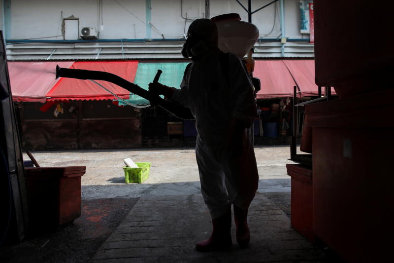 A City Hall worker sprays disinfectant at the Klong Toey fresh market after it was temporarily shut down amid the coronavirus disease outbreak in Bangkok on Friday. (Reuters photo)