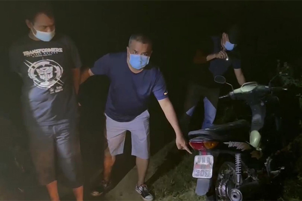 Anirut Panchuay (left) is arrested by plainclothes police with a stolen motorcycle in Hat Yai district of Songkhla on Sunday night. (Photo: Assawin Pakkawan)