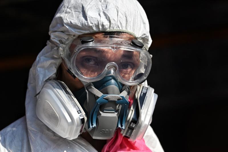 A man wearing personal protective equipment (PPE) prepares to spray disinfectant around Klong Toey fresh market after it was temporarily shut down due to several vendors testing positive for the Covid-19 novel coronavirus, in Bangkok on Jan 14, 2021. (AFP file photo)