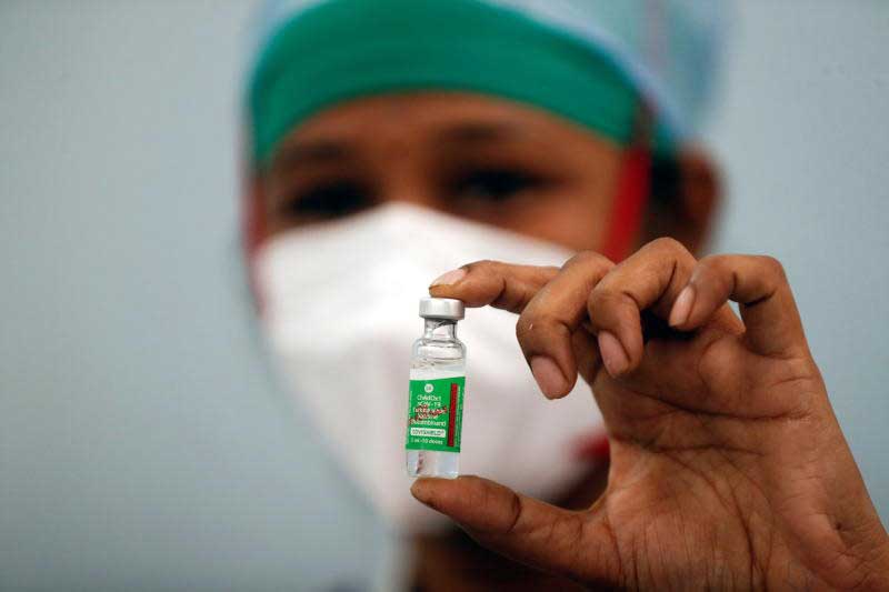 A nurse displays a vial of AstraZeneca's COVISHIELD vaccine during the coronavirus disease vaccination campaign at a medical centre in Mumbai on Saturday. (Reuters photo)