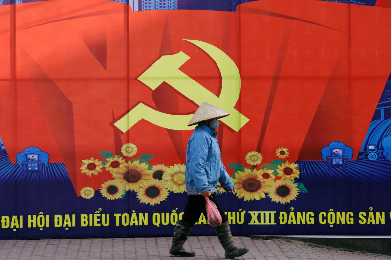 A woman wearing a traditional conical hat walks past a poster for the upcoming 13th national congress of Vietnam Communist Party on a street in Hanoi, Vietnam on Monday. (Reuters photo) A woman wearing a traditional conical hat walks past a poster for the upcoming 13th national congress of Vietnam Communist Party on a street in Hanoi, Vietnam on Monday. (Reuters photo)