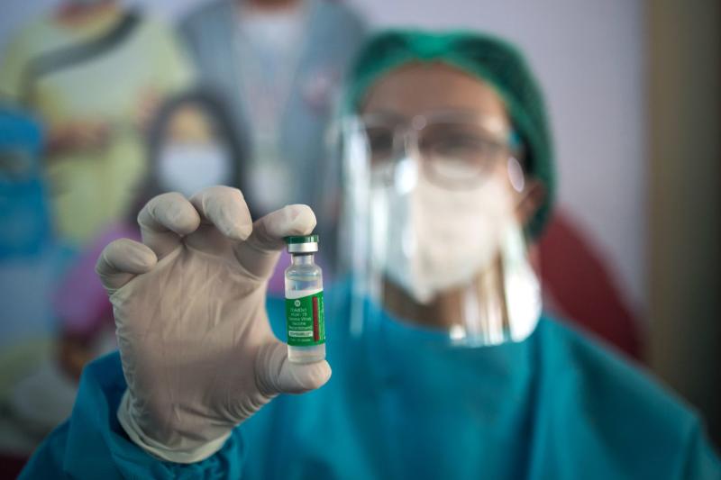 A health worker holds up a vial of Covishield, AstraZeneca-Oxford's Covid-19 coronavirus vaccine, at the Ayeyarwady Covid Center in Yangon on Wednesday. (AFP photo)