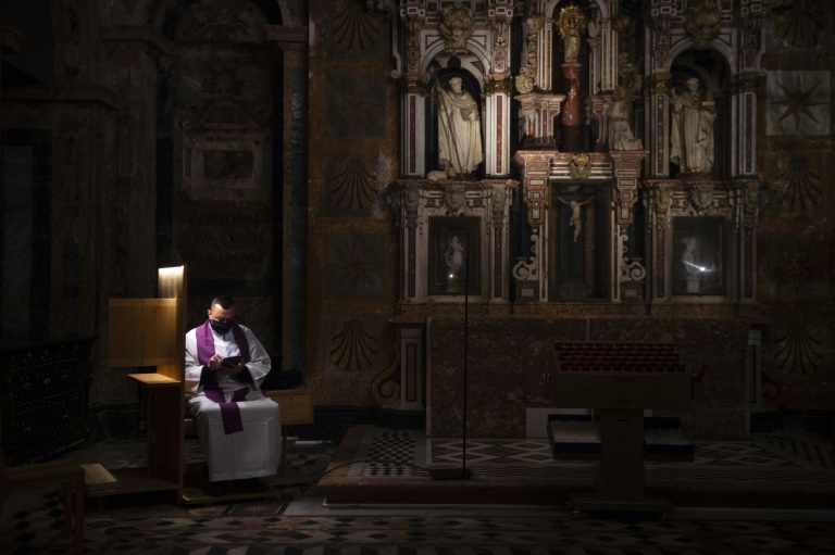 A Spanish priest presides over an empty cathedral as virus cases worldwide topped 100 million. A Spanish priest presides over an empty cathedral as virus cases worldwide topped 100 million.