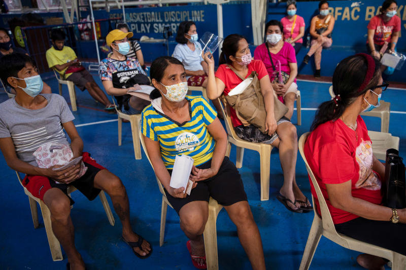 Gemma Roxas, 57, wearing a protective mask for protection against the coronavirus disease (Covid-19), queues for a general check-up at a local health center in Manila, Philippines Jan 26, 2021. (Reuters file photo)