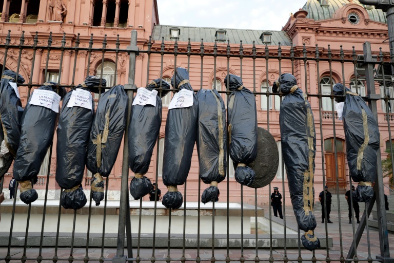 Demonstrators hung mock body bags in front of the Casa Rosada presidential office in Buenos Aires to protest against a scandal over vaccine line-jumping Demonstrators hung mock body bags in front of the Casa Rosada presidential office in Buenos Aires to protest against a scandal over vaccine line-jumping