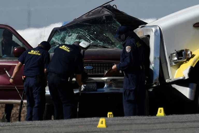Investagators inspect the crash between an SUV and semi-truck near Holtville, California on March 2, 2021 Investagators inspect the crash between an SUV and semi-truck near Holtville, California on March 2, 2021