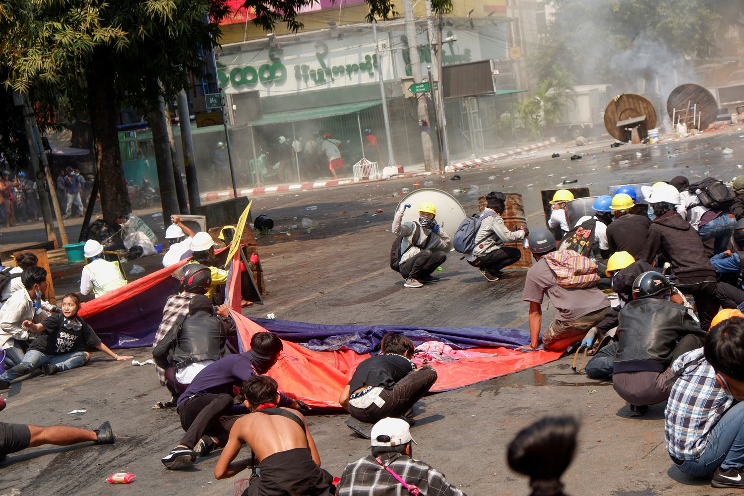 Protesters lie on the ground after police open fire to disperse an anti-coup protest in Mandalay, Myanmar, on Wednesday. (Reuters photo) Protesters lie on the ground after police open fire to disperse an anti-coup protest in Mandalay, Myanmar, on Wednesday. (Reuters photo)