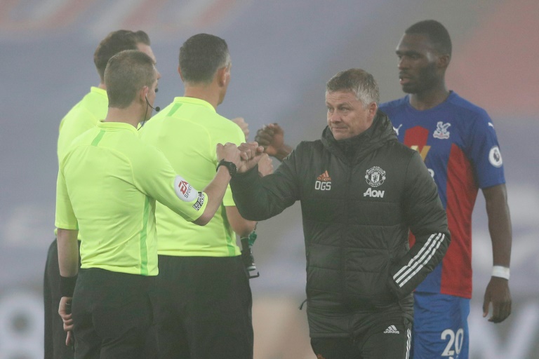 Frustration in the fog - Solskjaer (second right) shakes hands with the referee and his assistants after a goalless draw away to Crystal Palace. Frustration in the fog - Solskjaer (second right) shakes hands with the referee and his assistants after a goalless draw away to Crystal Palace.