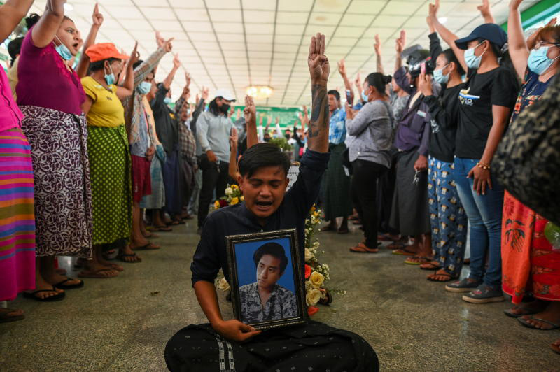 People flash a three-finger salute as they attend the funeral of victims shot dead during the anti-coup protest in Yangon. Another man was killed during a rally in Mandalay on Friday. (Photo: Reuters)