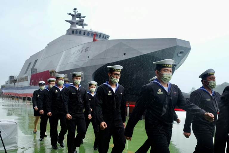 Navy sailors walk past a ship in Taiwain, which faces a constant threat of invasion by China. Navy sailors walk past a ship in Taiwain, which faces a constant threat of invasion by China.