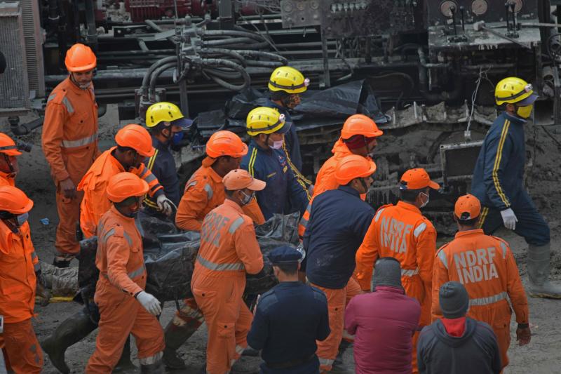 National Disaster Response Force (NDRF) crew carry the body of a victim following rescue efforts from Tapovan tunnel in Chamoli on Feb 14, 2021, after flash floods thought to have been caused when a glacier broke off on Feb 7. (AFP file photo) National Disaster Response Force (NDRF) crew carry the body of a victim following rescue efforts from Tapovan tunnel in Chamoli on Feb 14, 2021, after flash floods thought to have been caused when a glacier broke off on Feb 7. (AFP file photo)