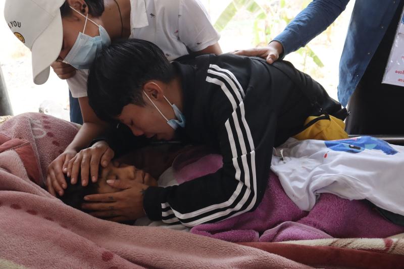 Family members grieve over the body of teenage bystander Tun Tun Aung at a cemetery in Mandalay on Tuesday, a day after he was shot dead in front of his home by security forces during a crackdown on demonstrations against the military coup. (AFP photo) Family members grieve over the body of teenage bystander Tun Tun Aung at a cemetery in Mandalay on Tuesday, a day after he was shot dead in front of his home by security forces during a crackdown on demonstrations against the military coup. (AFP photo)
