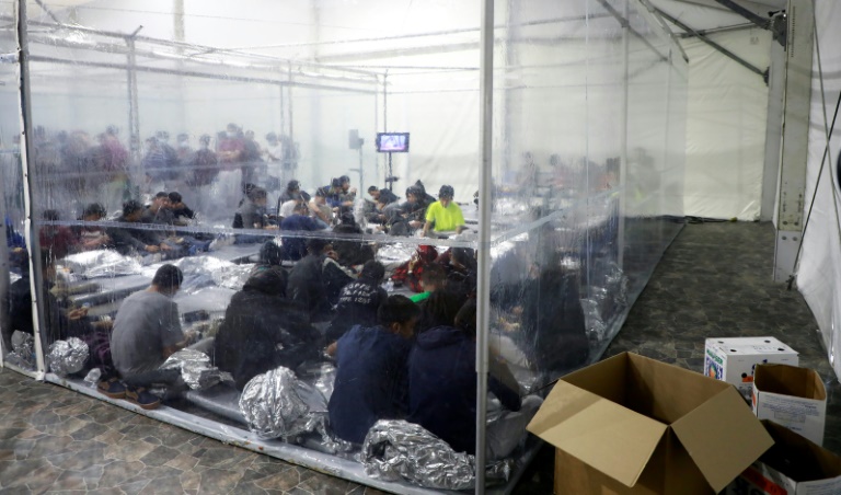 Migrants crowd a temporary processing center in Donna Texas
