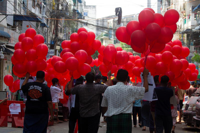 Protesters prepare to release red balloons during a demonstration against the military regime in Yangon on Wednesday. (Reuters photo)