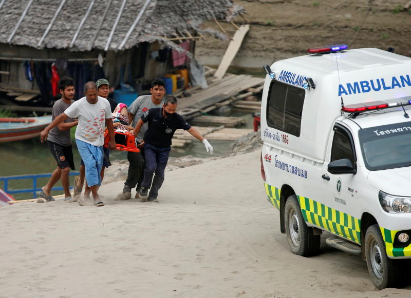 Rescue workers and soldiers carry a wounded person who is fleeing the violence in Myanmar and seeking medical treatment at the Thai border village of Mae Sam Laep, Mae Hong Son province, on Tuesday. (Reuters photo)