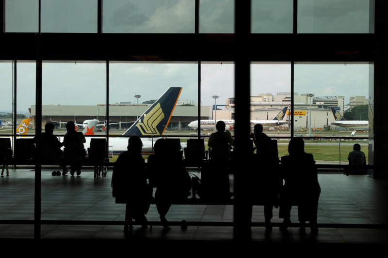 People look at a Singapore Airlines plane, amid the spread of the coronavirus disease , at a viewing gallery of Changi Airport in Singapore. (Reuters file photo) People look at a Singapore Airlines plane, amid the spread of the coronavirus disease , at a viewing gallery of Changi Airport in Singapore. (Reuters file photo)
