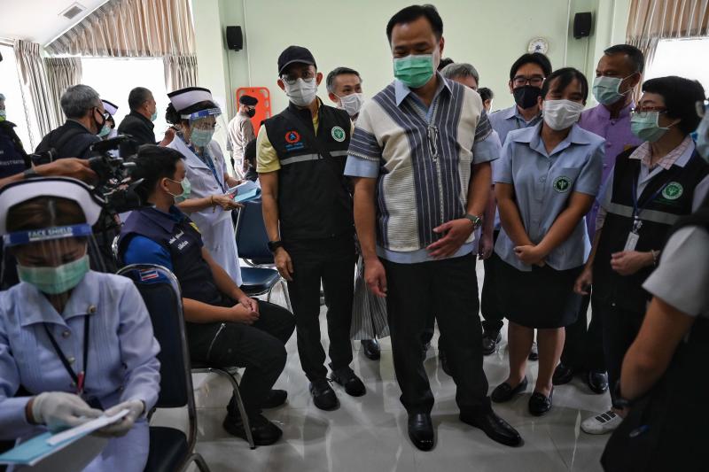 FILE PHOTO: Deputy Prime Minister and Health Minister Anutin Charnvirakul, wearing a traditional Karen shirt, watches nurses administer the Coronavac vaccine to frontline health workers after he arrived to hand over 2,000 vials of the vaccine and other medical supplies to frontline workers to combat the spread of the Covid-19 coronavirus, as authorities fear a further influx of Myanmar refugees over the border, at Mae Sariang Hospital in Mae Hong Son province on April 2, 2021. (AFP)