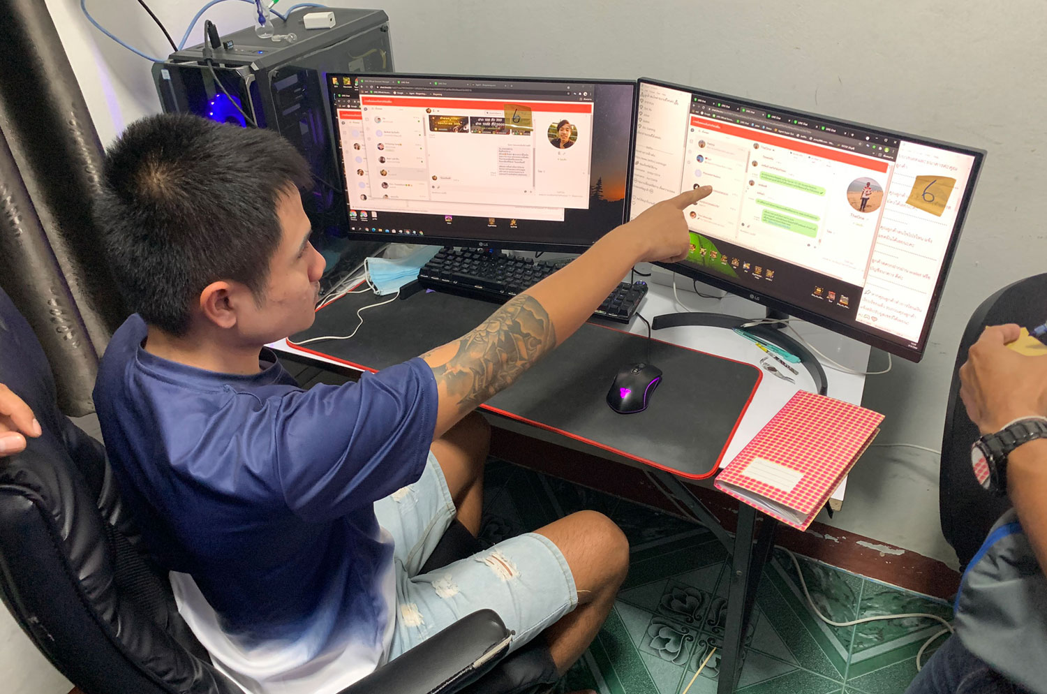 An alleged administrator of an online gambling network points out details of a customer placing a bet to arresting police in Nang Rong area of Buri Ram. He was among 16 people arrested during CSD raids. (Photo supplied/ Wassayos Ngamkham) An alleged administrator of an online gambling network points out details of a customer placing a bet to arresting police in Nang Rong area of Buri Ram. He was among 16 people arrested during CSD raids. (Photo supplied/ Wassayos Ngamkham)