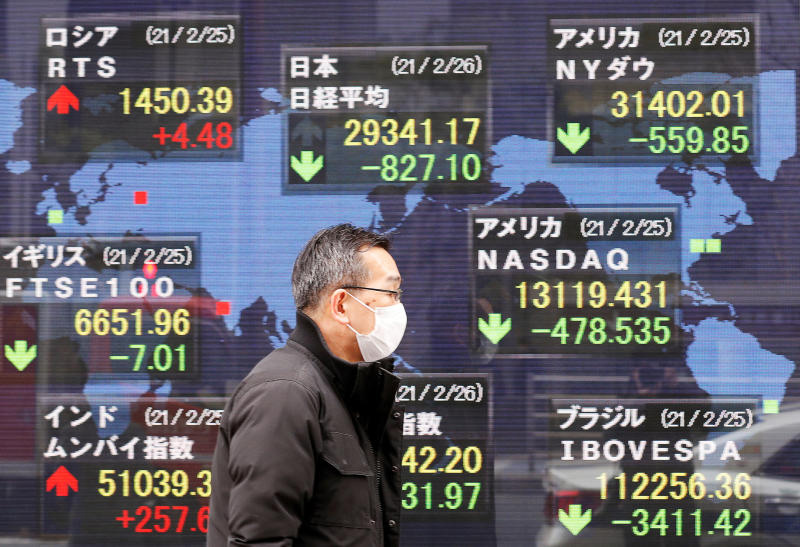 A man walks past a stock quotation board at a brokerage in Tokyo on Feb 26, 2021. (Reuters photo) A man walks past a stock quotation board at a brokerage in Tokyo on Feb 26, 2021. (Reuters photo)