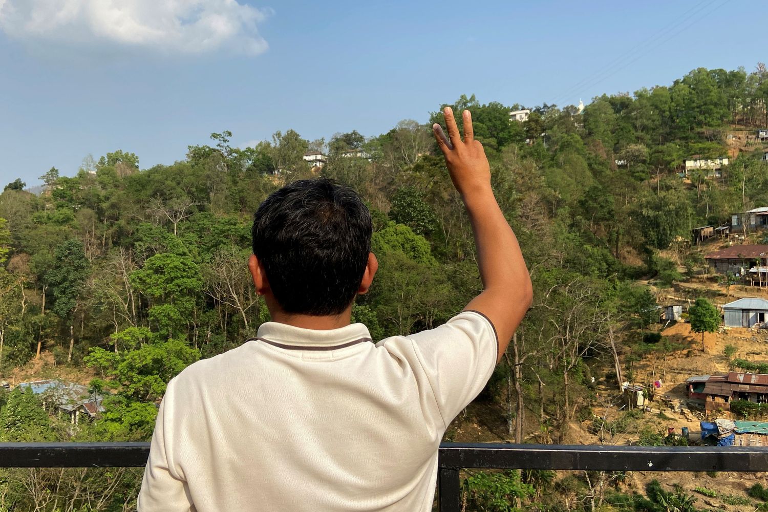 An ousted member of parliament from Myanmar flashes a three-finger salute at an undisclosed location in northeastern India on Tuesday. (Reuters photo) An ousted member of parliament from Myanmar flashes a three-finger salute at an undisclosed location in northeastern India on Tuesday. (Reuters photo)