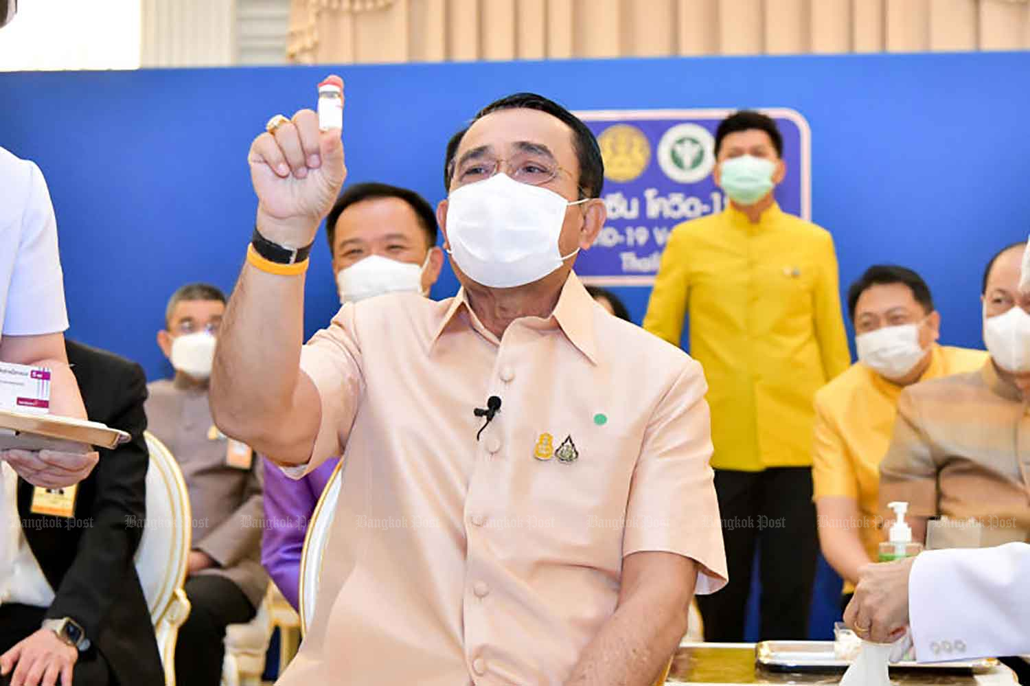 Prime Minister Prayut Chan-o-cha shows a vial of AstraZeneca vaccine before being inoculation against Covid-19 at Government House in Bangkok on March 16. (Government House photo)