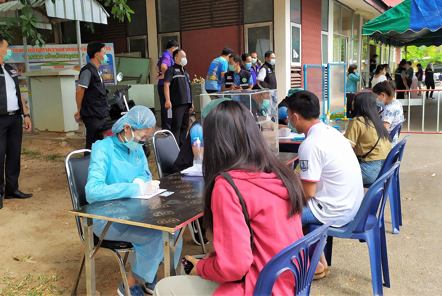 People take Covid-19 tests outside Nakhon Phanom provincial hall on Tuesday, when 10 new infections were confirmed in the northeastern province. (Photo: Pattanapong Sripiachai)