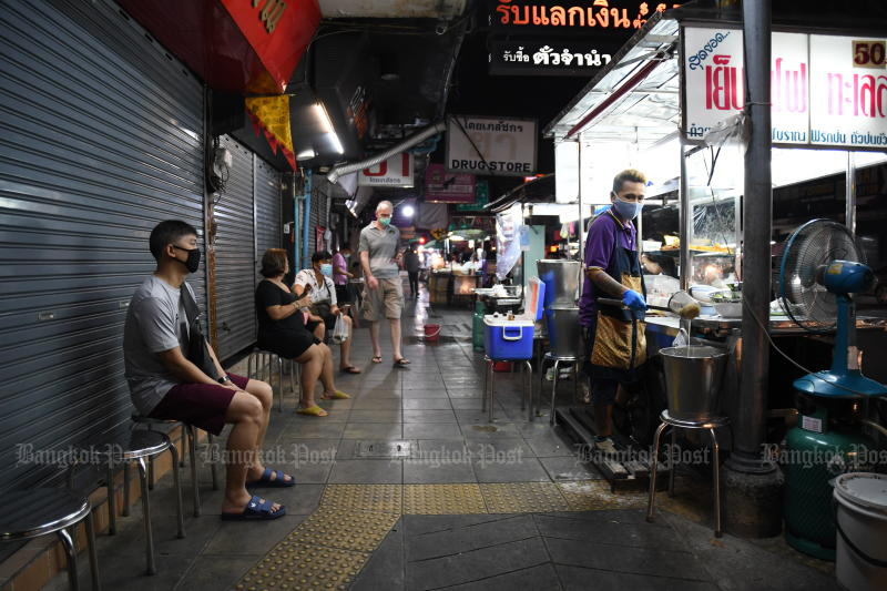 Customers wait for their noodle soup at a roadside shop on Padiphat Road in Bangkok on Saturday. (Photo by Nutthawat Wicheanbut)