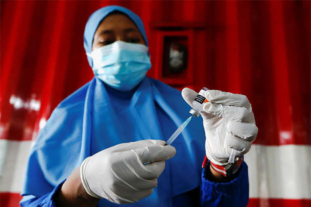 A healthcare worker prepares a dose of China's Sinovac vaccine at a drive-thru vaccination station, as a mass vaccination programme continues in Jakarta on Friday. (Reuters photo)