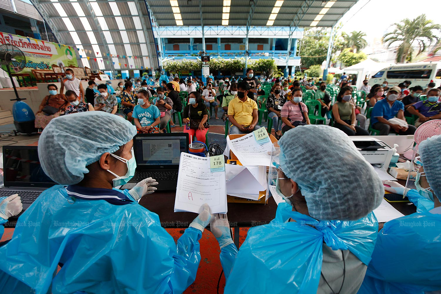 Clean send-off: Monks in protective overalls spray disinfectant around the crematorium at Wat Bang Muang in Nonthaburi’s Bang Yai district, one of the temples equipped to cremate the bodies of those who died of Covid-19. (Photo by Pattarapong Chatpattarasill)