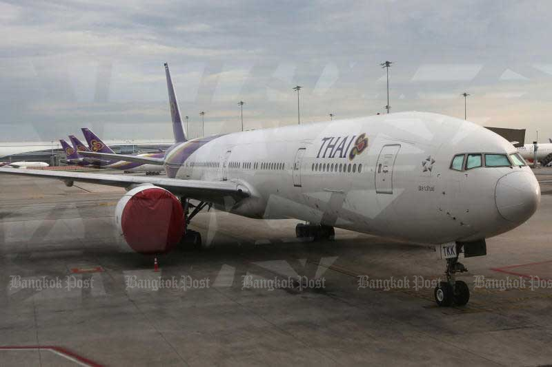 A Thai Airways International jet sits parked on the tarmac of Suvarnabhumi airport. (Photo by Wichan Charoenkiatpakul)