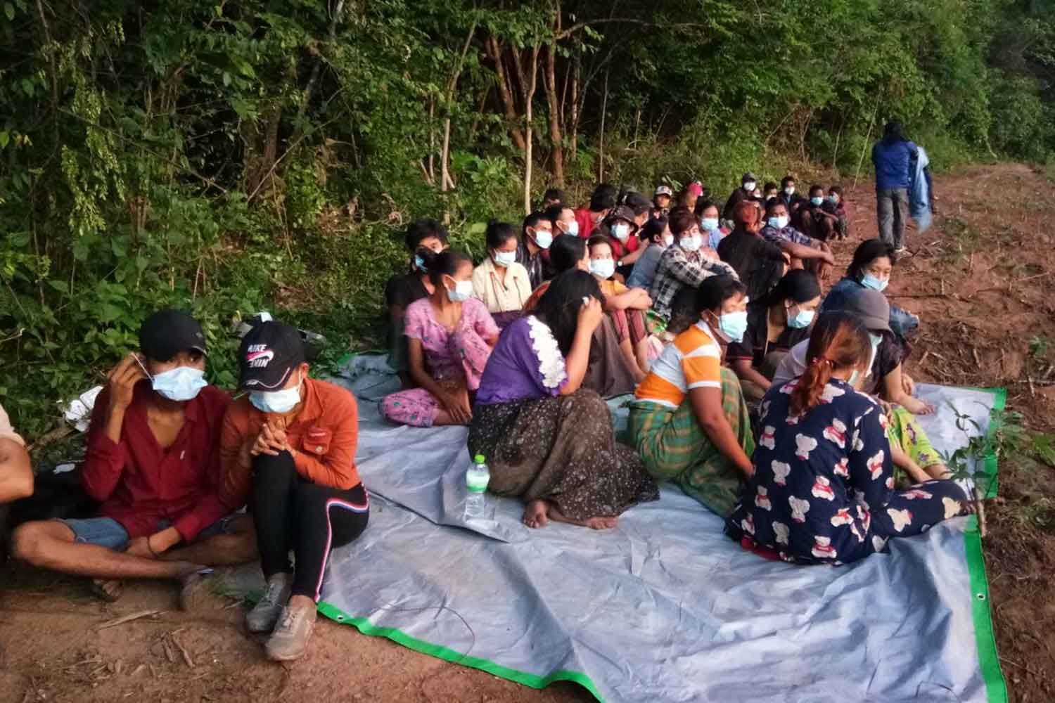 Forty-nine Myanmar job seekers caught near a village in Kanchanaburi's Muang district after sneaking across the border on Tuesday morning. (Photo: Piyarat Chongcharoen)