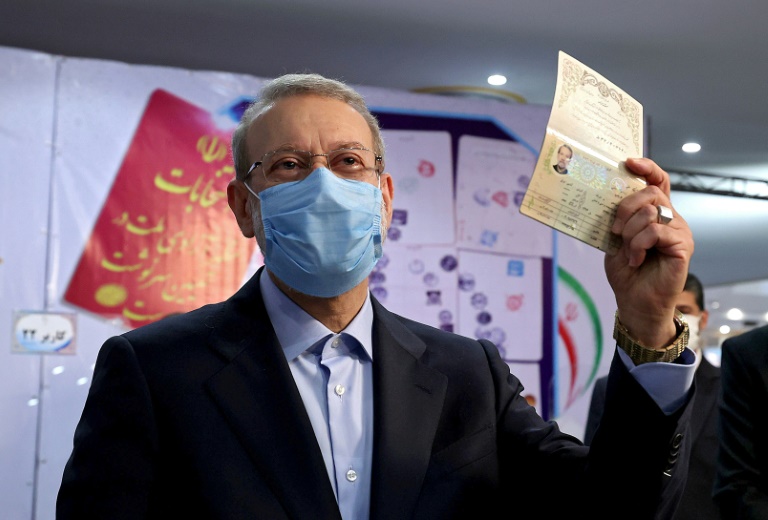 Iran's former parliament speaker Ali Larijani raises his passport as he registers his candidacy for Iran's presidential elections Iran's former parliament speaker Ali Larijani raises his passport as he registers his candidacy for Iran's presidential elections