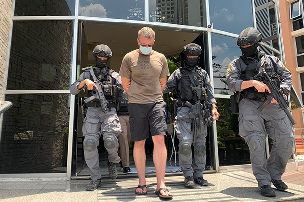 Crime Suppression Division police escort one of two American nationals arrested over the alleged kidnapping of a Taiwanese businessman on Saturday. (Crime Suppression Division photo)