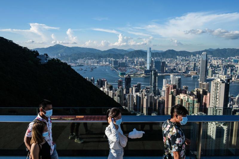 In this file photo taken on July 28, 2020, visitors walk along a viewing platform on Victoria Peak in Hong Kong. (AFP) In this file photo taken on July 28, 2020, visitors walk along a viewing platform on Victoria Peak in Hong Kong. (AFP)